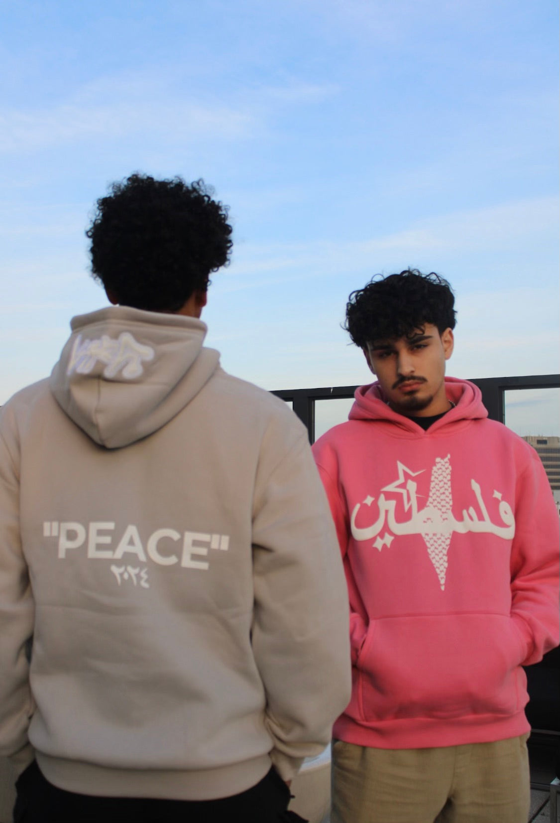 Model wearing Peace Grey Hoodie, a modern Arab streetwear piece with Kufiya-inspired design and Arabic typography.