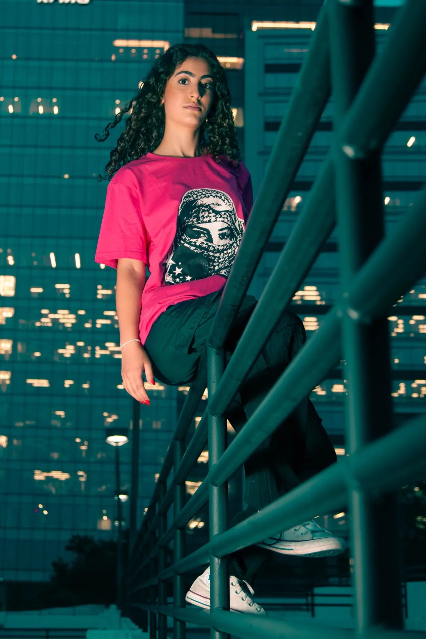 Model in movement wearing Rose Kufiya Graphic Tee, representing activism through socially conscious streetwear.