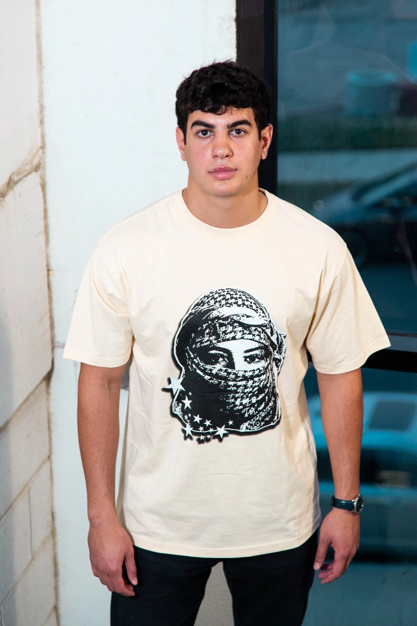 Model of a man wearing the Sand Kufiya Graphic Tee, merging cultural fashion with Streetwear.