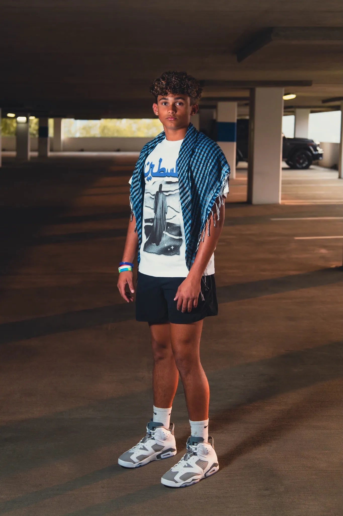 Model wearing the Snow Palestine Graphic Tee in an urban setting, pairing cultural heritage with modern Arab streetwear. A perfect blend of political fashion and contemporary design.