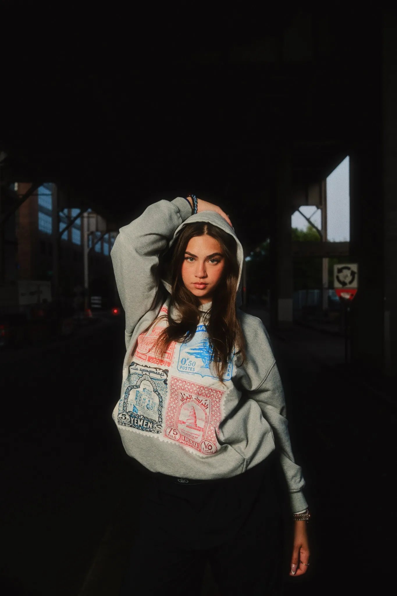 A model Olivia wearing Arab Clothing Stamp Hoodie. This Arab Streetwear style looks very nice.slider_item_KMNnDx