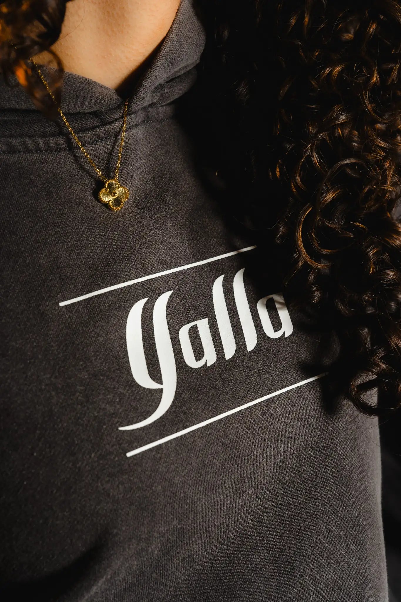 Close-up of front Yalla logo on Timeless Arab Hoodie, part of modern Arab streetwear and cultural fashion.